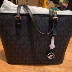 Black Michael Kors purse jet travel